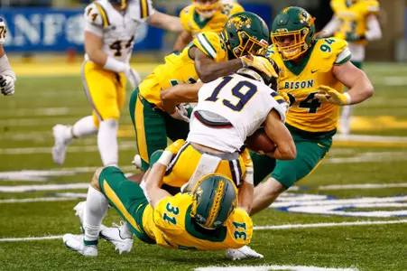 Courtney Eubanks, Costner Ching and Cole Wisniewski make a tackle
