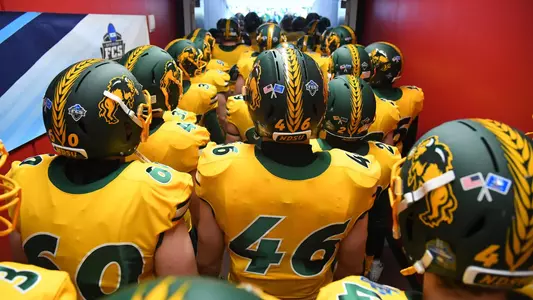 Austin Avery and NDSU football teammates walk down stairs