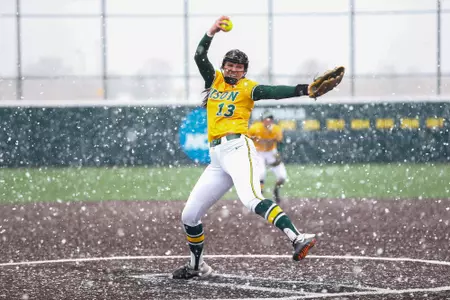 Lainey Lyle pitches a softball in the snow
