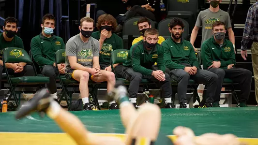 NDSU wrestlers look on from the bench