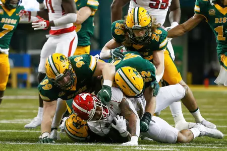 NDSU's Spencer Waege, Jackson Hankey and James Kaczor make a tackle