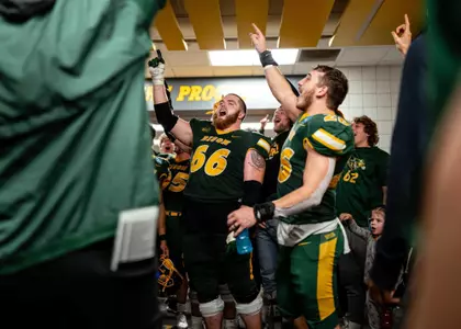Nash Jensen (66) and the Bison celebrate after the win over Samford