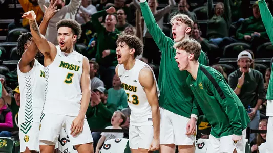 NDSU men's basketball bench celebrates