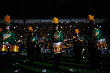 Gold Star Marching Band drums perform in a darkened Fargodome