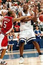 Demetrius Porter slaps the<br>ball away from BYU's<br>Silester Rivers during<br>the first half.