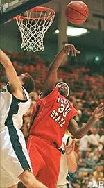 Utah State's Dan Stewart and Fresno State's Melvin Ely compete for a rebound during first-half action in Logan, Utah Tuesday.
