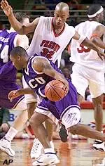 Courtney Alexander tries to prevent TCU's Larry Allaway from driving to the basket in Sunday night's action.