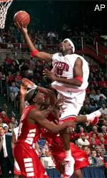 Fresno State's Melvin Ely goes up for a lay-up over Southern Methodist's Jeryl Sasser, rear, and Willie Davis, left, Saturday.(AP Photo/The Fresno Bee, Tomas Ovalle)