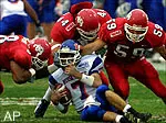 Boise State quarterback Ryan Dinwiddie is surrounded by Fresno State defensive players, Alan Harper, Maurice Rodriguez and Jake Probst in the first quarter Friday.