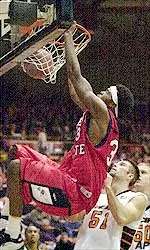Fresno State center Melvin Ely dunks over Pacific's Mike Preston (51) and Ross Mills in the first half