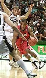 Chris Jefferies cuts between Hawaii's Predrag Savovic and Paul Jesinskis.