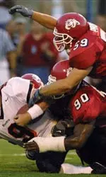 Nick Burley and Jake Probst stop Oregon's Jonathan Smith from gaining a first down in the the first half Sunday.