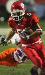Adam Jennings runs past Boise State's Marty Tadman in the first half.