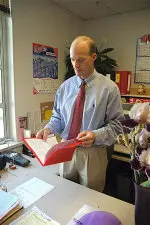 Associate Athletics Director Randy Welniak reviews team travel information. Welniak started his position at Fresno State in 2002.