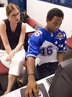 A good part of Kelly's day is spent one-on-one with student-athletes and their educational needs. Here Kelly sits down with junior running back Clifton Smith to help him with his CD-Rom class.