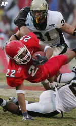 Anthony Harding is tripped up by Idaho's Chris Smith in the second half. (AP Photo/Gary Kazanjian)
