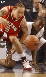 Dwight O'Neil and Nevada's Marcelus Kemp fight for a loose ball during the first half. O'Neil scored 14 points and shared team high honors in rebounds (7) in the season finale.  (AP Photo Brad Horn)