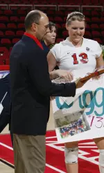 Head Coach Ruben Nieves hands senior Angela Wiggins her senior gift before Thursday's match.