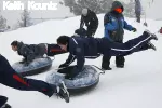 Greg Titiriga leaps on the tube to head down the hill during the Winter Sports Day at Bogus Basin in Boise, Idaho.