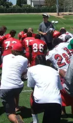 Pat Hill speaks to his team Monday afternoon during the first day of training camp.