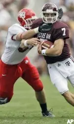 Ben Jacobs tries to bring down Texas A&M quarterback Stephen McGee during the first quarter. (AP)