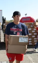 Fresno State student-athletes including, baseball player Danny Muno helped distribute food on Monday.