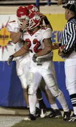 Tom Brandstater congratulates Anthony Harding following Harding's touchdown scamper. (AP Photo/Paul Sakuma)