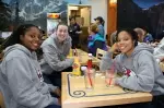 Marnique Arnold, Brittny Jones and Hayley Munro wait for their lunch at the Fresno Airport before departing for Dallas, Tx.
