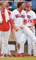 Steve Detwiler celebrates with the team outside the dugout after Steve Susdorf's two-run homer on Tuesday.