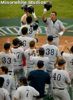 Steve Detwiler is greeted by his teammates after scoring a run for the Bulldogs.