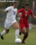 Alires wins the ball away from an opponent.