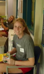 Freshman Bri Clarke with Lacey Gera in the background wait to read to patients at the Heart Center.