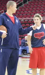 Head women's coach Adrian Wiggins and star guard Emma Andrews talk through a drill during the Bulldogs' Community Hoops Night.