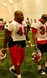 Reynard Camp heads out of the New Mexico indoor football complex after practice on Thursday.