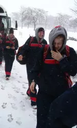 Rosie Moult and Jeanna Furst walk through the snow on the way to shoot around Saturday morning.