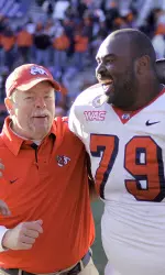 Fresno State's Devan Cunningham (79) celebrates with coach Pat Hill, after defeating Illinois 53-52 in the final seconds of an NCAA college football game in Champaign, Ill., Saturday, Dec 5, 2009. (AP Photo/Seth Perlman)