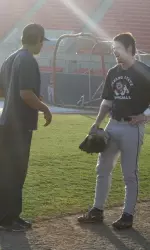 Volunteer assistant coach Gregg Raymundo gives freshman Brennan Gowens advice during the first practice of 2009.