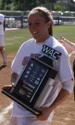 Haley Perkins hoists the 2009 WAC Tournament trophy after the Bulldogs defeated Nevada in the championship game at Bulldog Diamond.