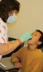 A Fresno child receiving care at the Team Smile event last year.