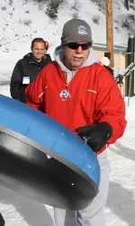 Fresno State head coach Pat Hill prepares to launch down the hill on an inner tube.
