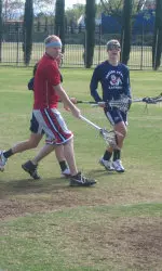 Clayton Clark plays a little lacrosse with Bulldog lacrosse players.