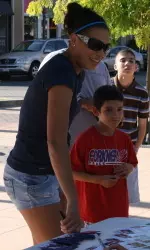 Kelli Parker meets a young fan as the team signed autographs at River Park on Thursday afternoon.