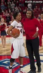 Yvette Roberts, right, presents Jaleesa Ross with the gameball after Ross breaks her 22-year-old scoring record.