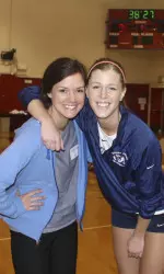 Former teammates Allanah Colburn (Munson) and Lauren Berger reunited in the North Gym at Saturday's alumni match.