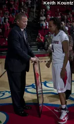 Jaleesa Ross, right, receives a framed jersey from Adrian Wiggins before becoming Fresno State's all-time leading scorer.