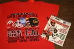 Grab your "Battle at the Stick," game day t-shirt to receive a free Lindy's College football magazine.