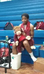 Crazy Monkey and sophomore Ki-Ki Moore ice their feet after practice.