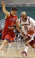 New Mexico State forward Tyrone Watson (45) drives past Fresno State guard Tyler Johnson (1). (AP Images)