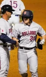 Assistant coach Brad Fontes congratulates Austin Guibor after his RBI double