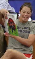 Senior Kara Conchek reading to the kindergarten class on Tuesday.